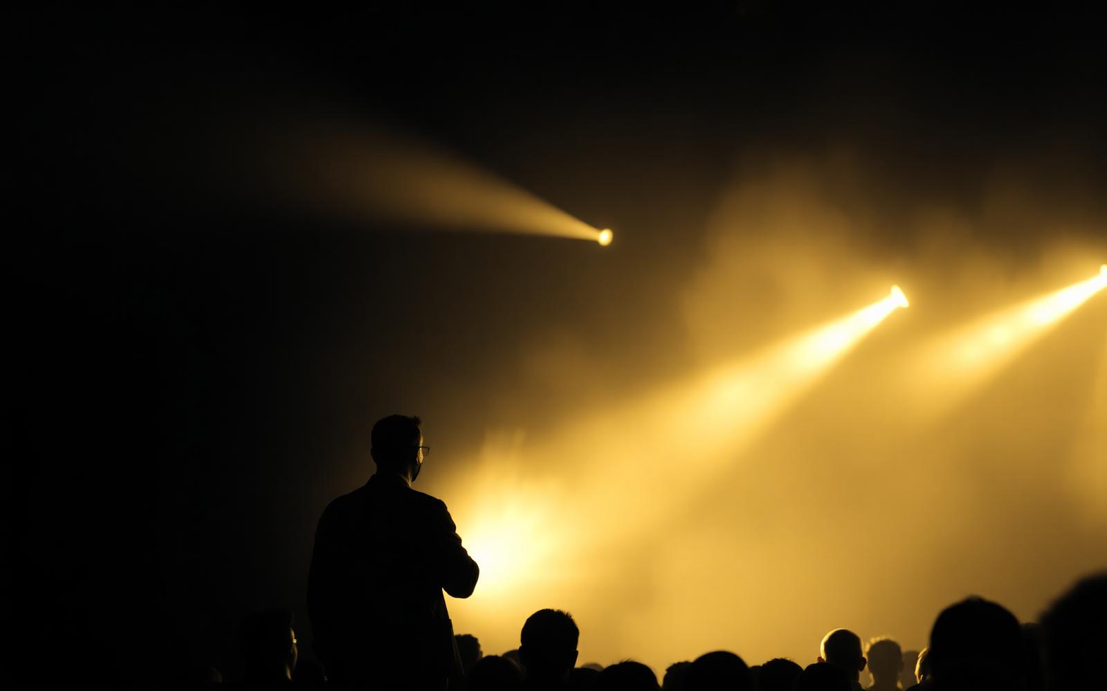 Speaker on stage with golden light